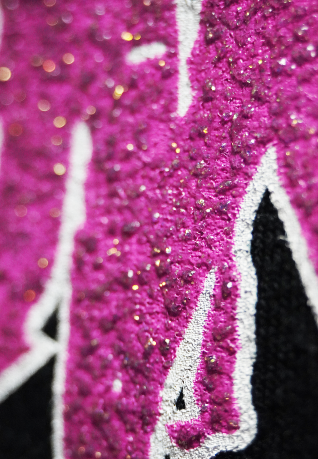 Specialty Ink, Glitter, Screenprint, Close-up of pink glittery letter 'M' on a black background