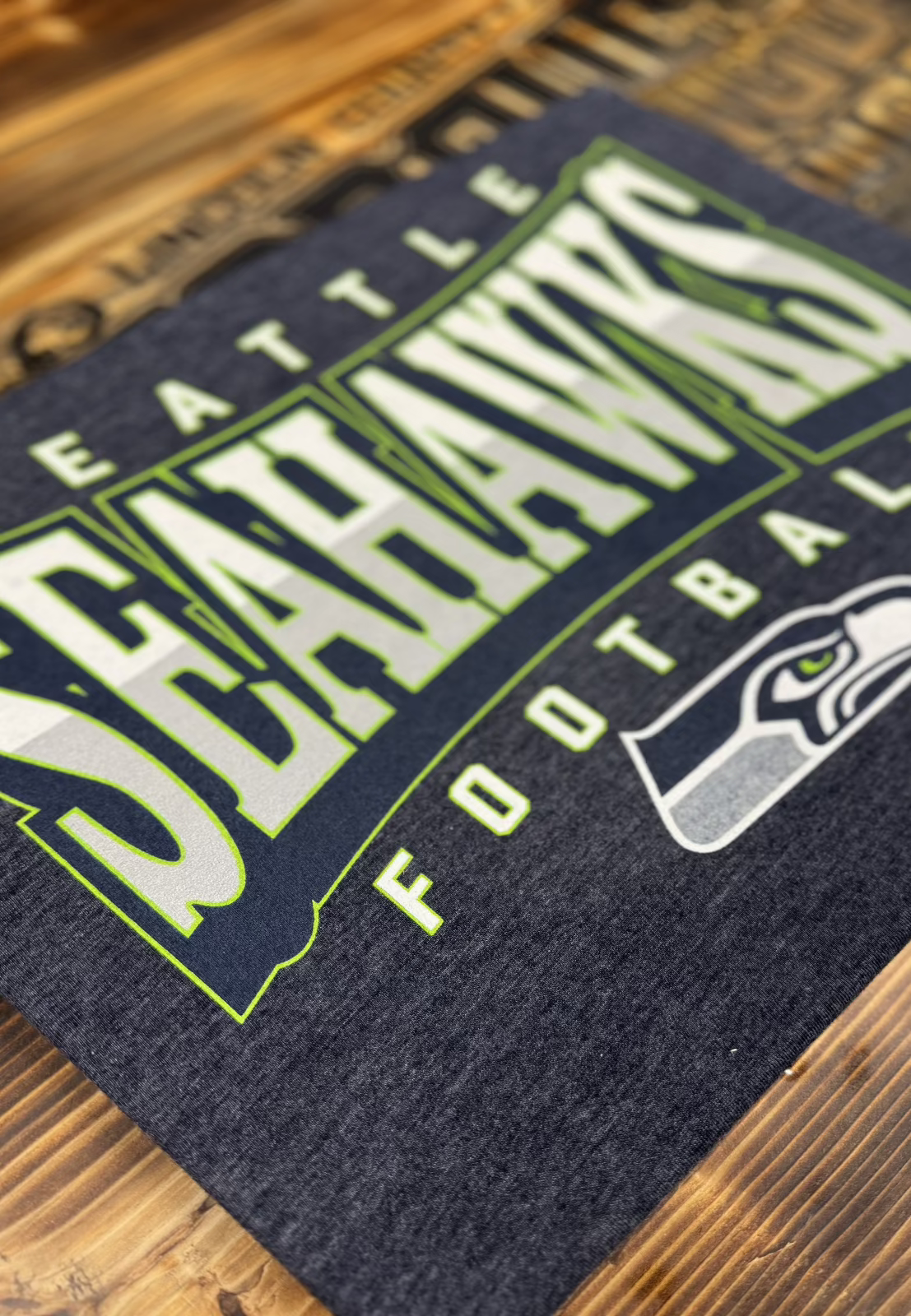 Side view of merch flat lay: tee, hoodie, hat, and promo accessories