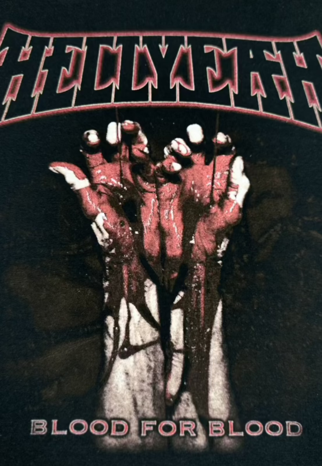 Side view of merch flat lay: tee, hoodie, hat, and promo accessories