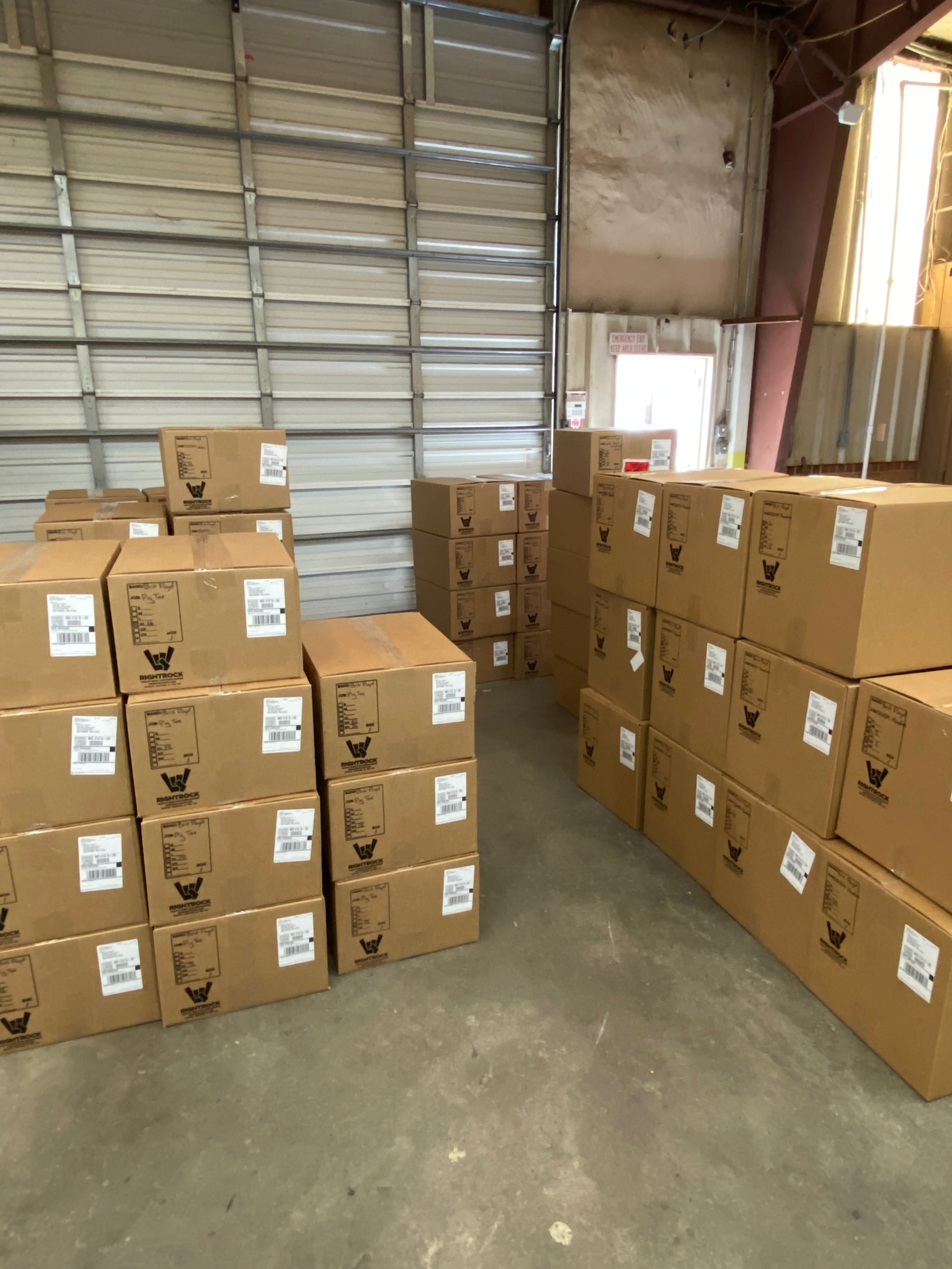 Merch orders boxed and ready to ship nationwide from Torches Print Shop