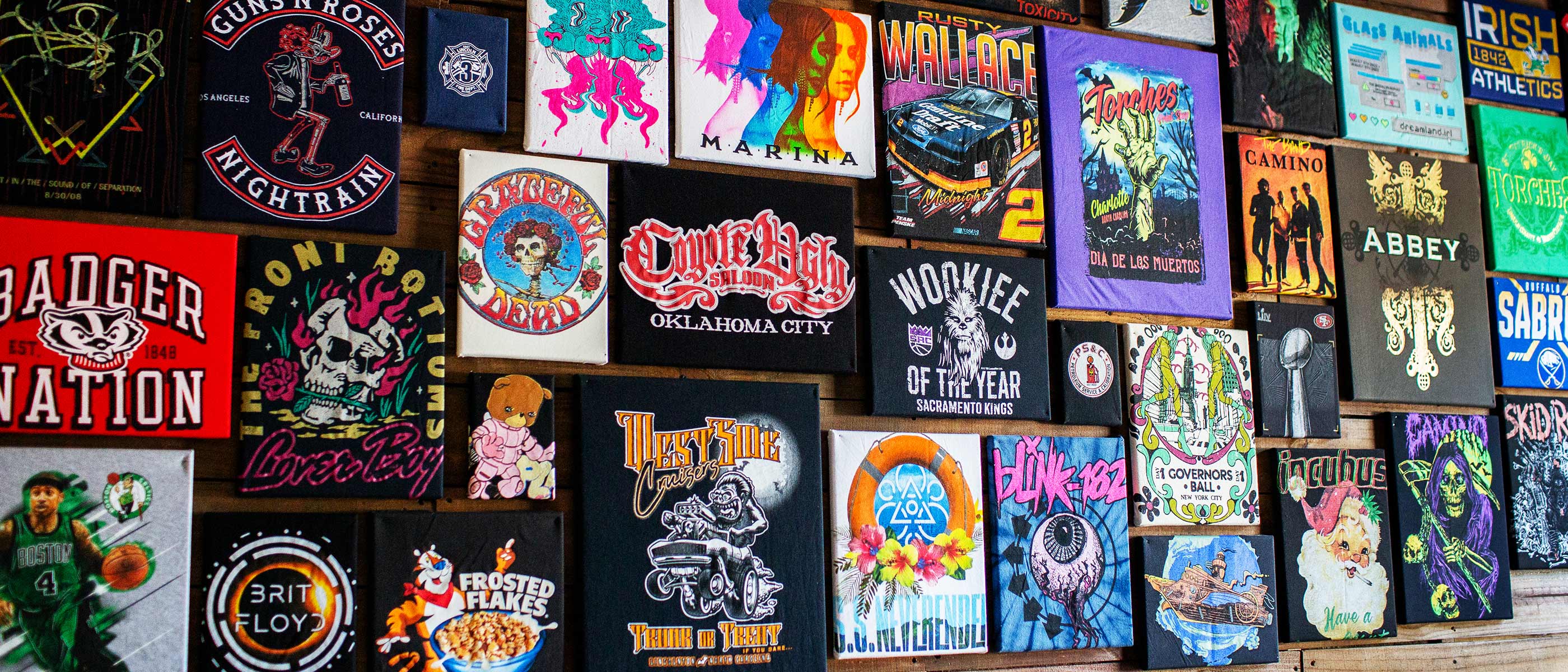 Side view of merch flat lay: tee, hoodie, hat, and promo accessories